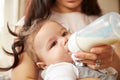 Mother Feeding Baby Boy From Bottle At Home Royalty Free Stock Photo