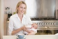 Mother feeding baby with coffee smiling Royalty Free Stock Photo