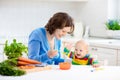 Mother feeding baby first solid food Royalty Free Stock Photo