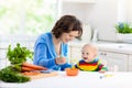 Mother feeding baby first solid food Royalty Free Stock Photo