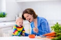 Mother feeding baby first solid food Royalty Free Stock Photo