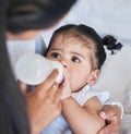 Mother feeding baby milk, formula and bottle with nutrition and family, healthy and growth with early childhood Royalty Free Stock Photo