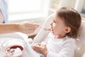 Mother feeding baby with puree at home Royalty Free Stock Photo