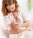 Mother feeding breast her baby in bed Royalty Free Stock Photo