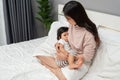 mother feeding breast her toddler baby on bed Royalty Free Stock Photo