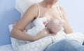 Mother feeding breast with nursing pillow Royalty Free Stock Photo