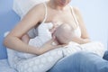 Mother feeding breast with nursing pillow Royalty Free Stock Photo