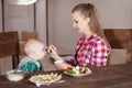 Mother feeding child. First solid food for young kid Royalty Free Stock Photo