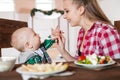 Mother feeding child. First solid food for young kid Royalty Free Stock Photo