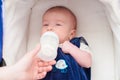 Mother feeding her baby from a bottle Royalty Free Stock Photo