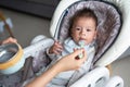 Baby boy being fed in his high chair at home Royalty Free Stock Photo