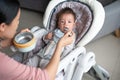 Baby boy being fed in his high chair at home Royalty Free Stock Photo