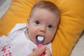 Mother feeding her baby girl with a spoon. Mother giving food to her four-month old baby Royalty Free Stock Photo