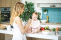 Mother Feeding Her Baby Girl with a Spoon. Mother Giving Food to her Child at Home. Baby food Royalty Free Stock Photo