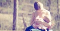 Mother feeding her baby in nature outdoors in the park Royalty Free Stock Photo