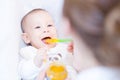 Mother feeding her lovely baby boy with spoon Royalty Free Stock Photo