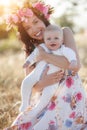 Mother feeding her newborn baby boy from bottle outdoors in the field. artifitial milk feedng Royalty Free Stock Photo