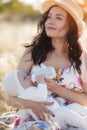 Mother feeding her newborn baby boy from bottle outdoors in the field. artifitial milk feedng Royalty Free Stock Photo