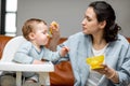 Mother feeding her one year baby boy with a spoon. Royalty Free Stock Photo