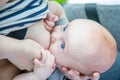 Mother feeding her son baby with breast in outdoors