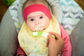 Mother feeding hungry five month old baby with spoon, solid food. Newborn feeding concept Royalty Free Stock Photo