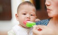 Mother feeding ice-cream for five month old infant baby boy Royalty Free Stock Photo