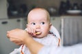 Mother feeding little baby with spoon Royalty Free Stock Photo