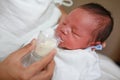 Mother feeding milk infant baby by glass cup Royalty Free Stock Photo