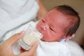 Mother feeding milk infant baby by glass cup Royalty Free Stock Photo