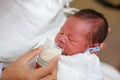 Mother feeding milk infant baby by glass cup Royalty Free Stock Photo