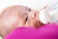 Mother feeding newborn baby boy with milk in nursing bottle Royalty Free Stock Photo
