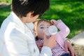 Mother feeding one year baby girl with feeding bottle Royalty Free Stock Photo