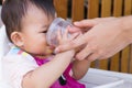 Mother feeding soup water for young kid eight month at home. Royalty Free Stock Photo