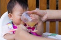 Mother feeding soup water for young kid eight month at home. Royalty Free Stock Photo