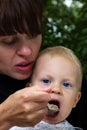 Mother feedings son Royalty Free Stock Photo