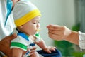 A mother feeds an adorable Asian baby boy. family concept Caring for newborn babies.