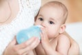 Mother feeds baby milk from bottle