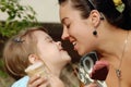 Mother feeds daughter with cavity a piece of chocolate ice cream, family