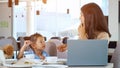 Mother feeds daughter in restaurant