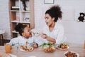 Mother Feeds Young Girl. Mom and Daughter Eat. Royalty Free Stock Photo