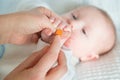 Mother filing and smoothing baby's fingernails Royalty Free Stock Photo