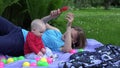 Mother fondle little child and play together outdoor in garden. 4K