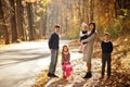 Mother with four kids in autumn park. Family walk in fall forest Royalty Free Stock Photo