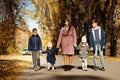 Mother with four kids in autumn park. Family walk in fall forest Royalty Free Stock Photo