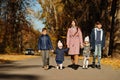 Mother with four kids in autumn park. Family walk in fall forest Royalty Free Stock Photo