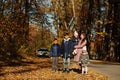 Mother with four kids in autumn park. Family walk in fall forest Royalty Free Stock Photo