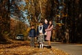 Mother with four kids in autumn park. Family walk in fall forest Royalty Free Stock Photo