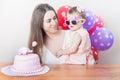 Mother with funny baby celebrating first birthday. Cake. Royalty Free Stock Photo