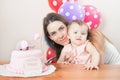Mother with funny baby celebrating first birthday. Cake. Royalty Free Stock Photo