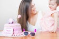 Mother with funny baby celebrating first birthday. Cake. Royalty Free Stock Photo